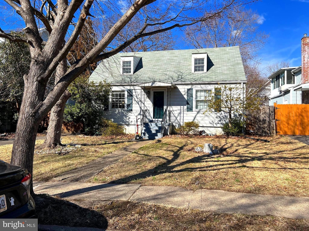 cape cod house with fence