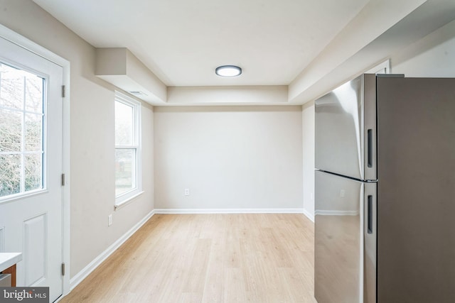 kitchen with visible vents, baseboards, freestanding refrigerator, light countertops, and light wood-style floors