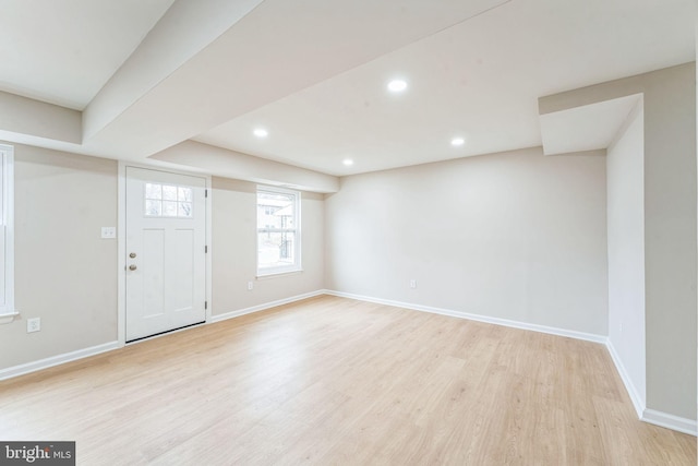 interior space featuring recessed lighting, baseboards, and light wood finished floors