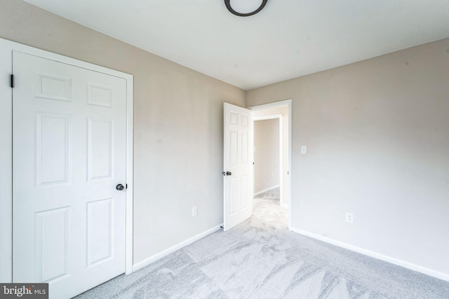 unfurnished bedroom featuring carpet floors and baseboards