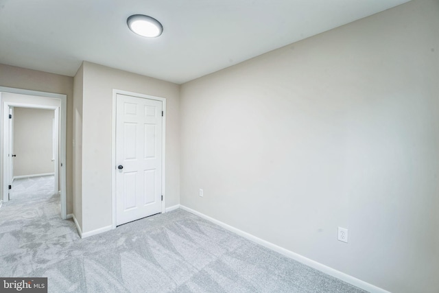 unfurnished bedroom with carpet flooring and baseboards