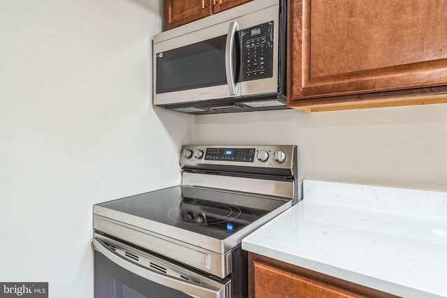 kitchen with brown cabinets and stainless steel appliances