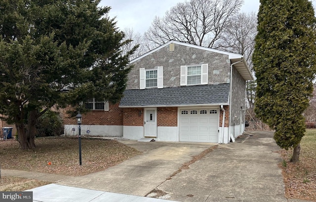 tri-level home with brick siding, a shingled roof, an attached garage, stone siding, and driveway