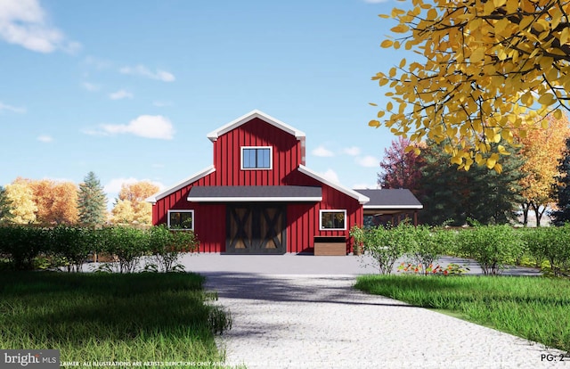 view of property featuring driveway and a barn