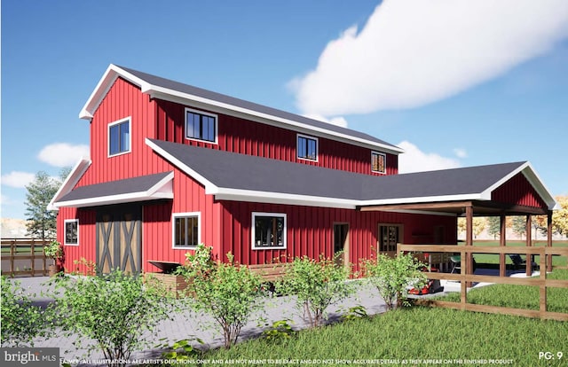 view of front of property featuring board and batten siding, an outbuilding, fence, and a barn