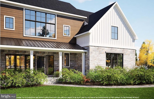 rear view of property featuring a standing seam roof, stone siding, metal roof, and board and batten siding