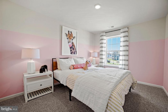 bedroom with carpet floors, visible vents, and baseboards