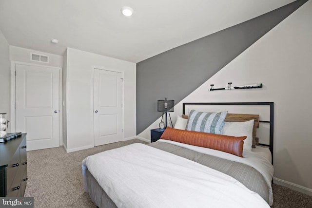 carpeted bedroom with visible vents and baseboards