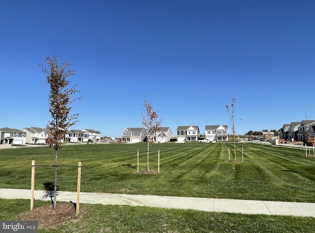 surrounding community featuring a lawn and a residential view