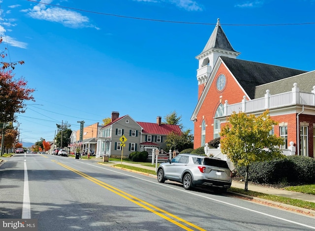 view of road with curbs, sidewalks, and a residential view