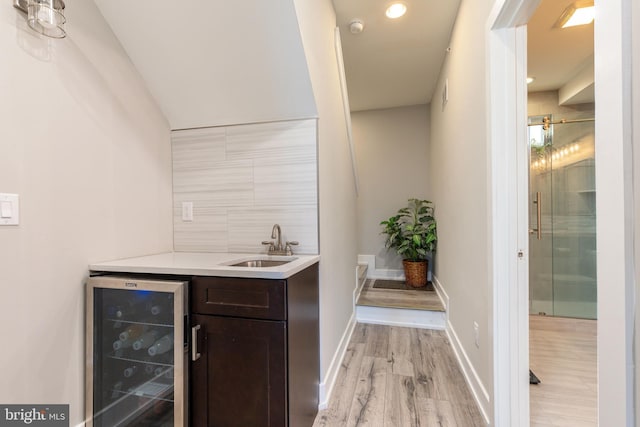 2525 N Hancock St, Philadelphia, PA 19133 - bar featuring baseboards, light wood-style flooring, wine cooler, a sink, and backsplash