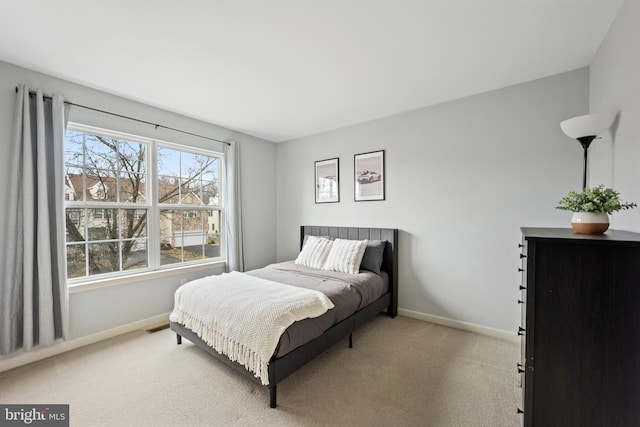 bedroom featuring carpet floors, visible vents, and baseboards