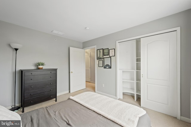 bedroom with light colored carpet, a closet, visible vents, and baseboards