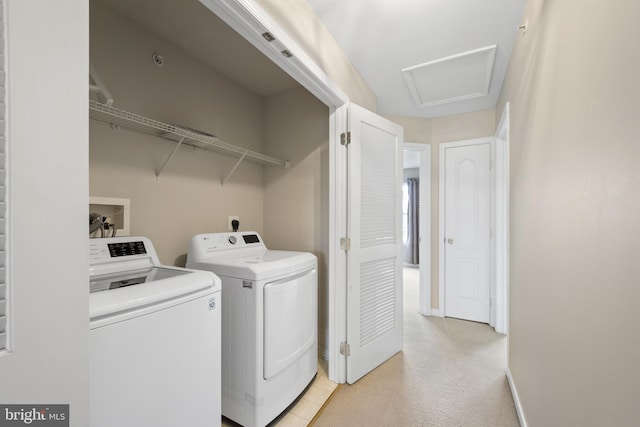 laundry area with laundry area, attic access, baseboards, and washer and clothes dryer