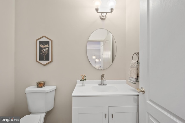 bathroom featuring toilet and vanity