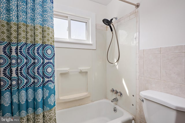 bathroom with toilet, shower / tub combo, and tile walls