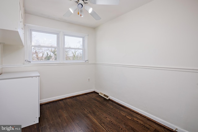 laundry area featuring dark wood-type flooring, a ceiling fan, visible vents, and baseboards