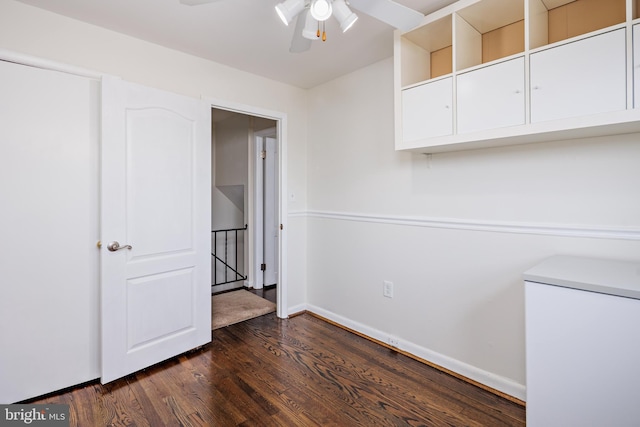 unfurnished room featuring ceiling fan, dark wood-style flooring, and baseboards