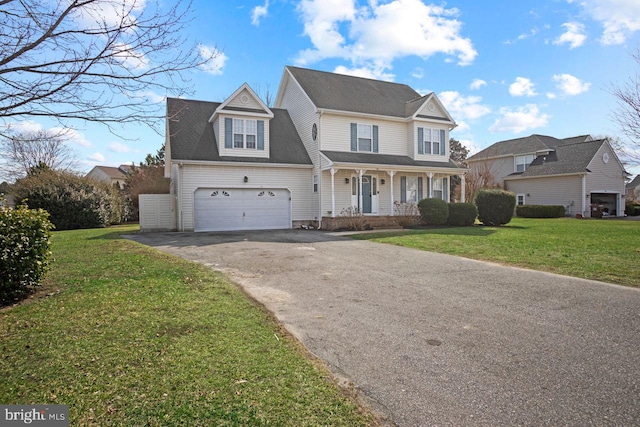 view of front facade with driveway, covered porch, a garage, and a front lawn