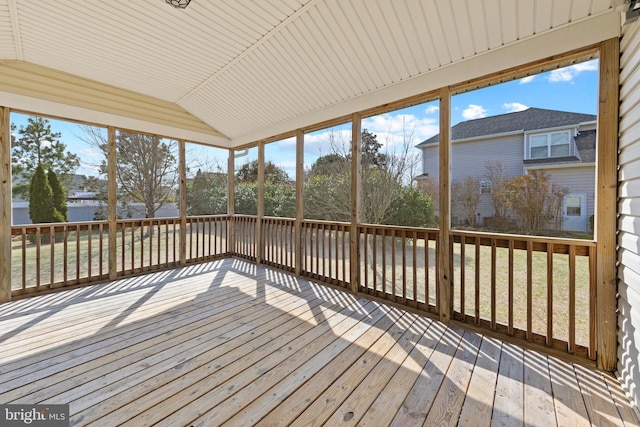 unfurnished sunroom featuring lofted ceiling