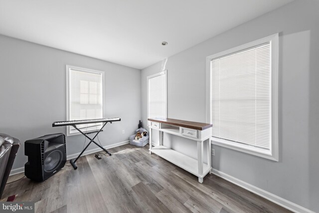 interior space featuring wood finished floors and baseboards