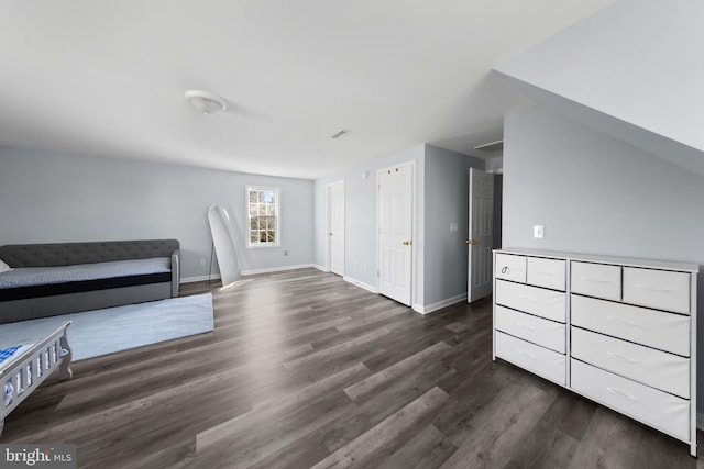 interior space with dark wood finished floors, visible vents, and baseboards