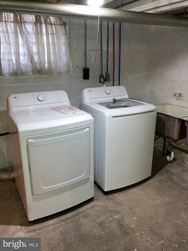 clothes washing area featuring laundry area and separate washer and dryer