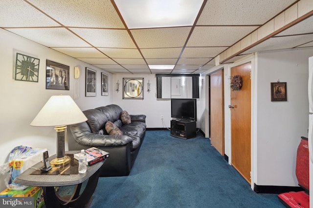 carpeted living room with a drop ceiling