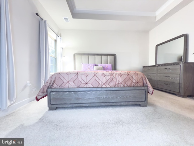 bedroom with a raised ceiling, carpet flooring, visible vents, and baseboards