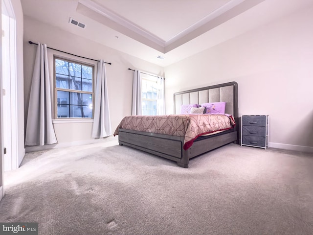 bedroom with carpet, a raised ceiling, visible vents, and baseboards