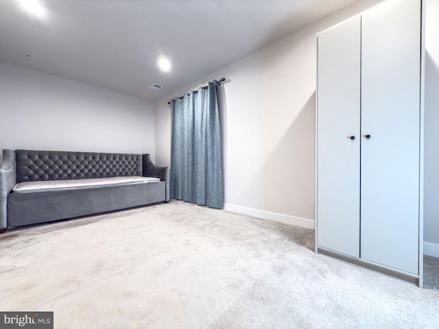 unfurnished bedroom featuring carpet floors, visible vents, and baseboards