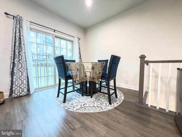 dining space featuring baseboards and wood finished floors