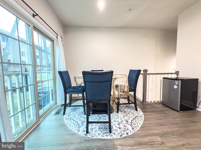 dining space with wood finished floors