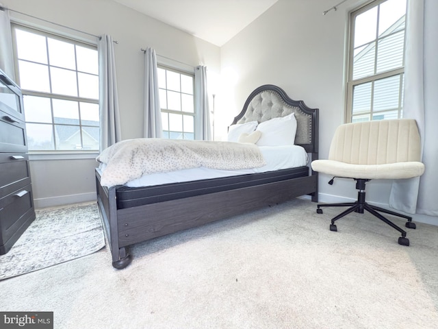 bedroom featuring light carpet and baseboards