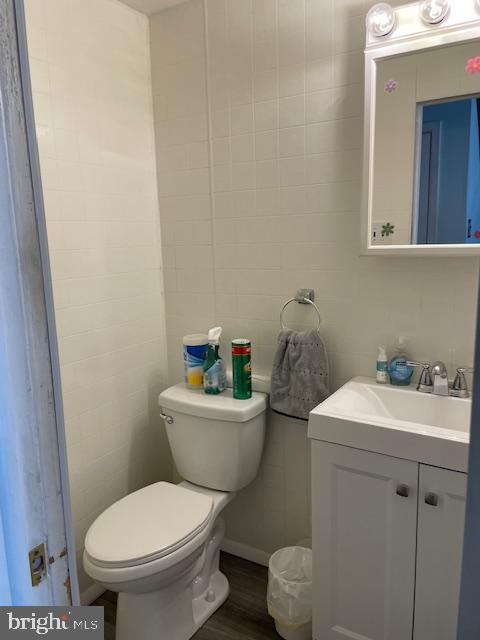 bathroom featuring wood finished floors, vanity, and toilet