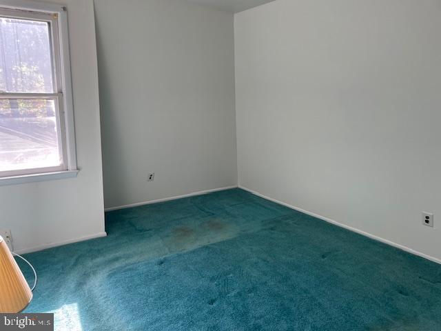 unfurnished room featuring carpet flooring