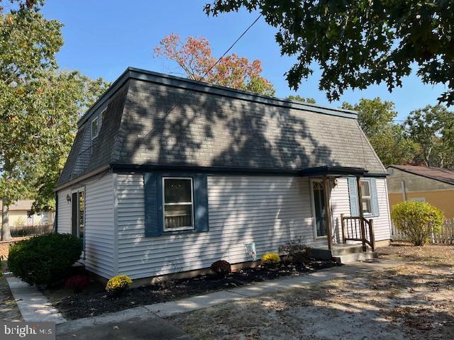 exterior space featuring a shingled roof