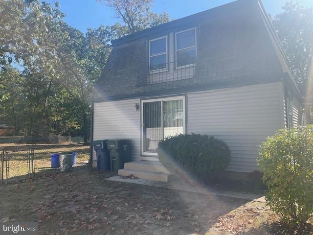 back of house featuring fence