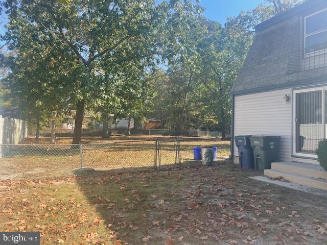 view of yard with entry steps and fence