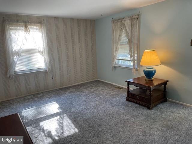 sitting room with carpet, baseboards, and a wealth of natural light