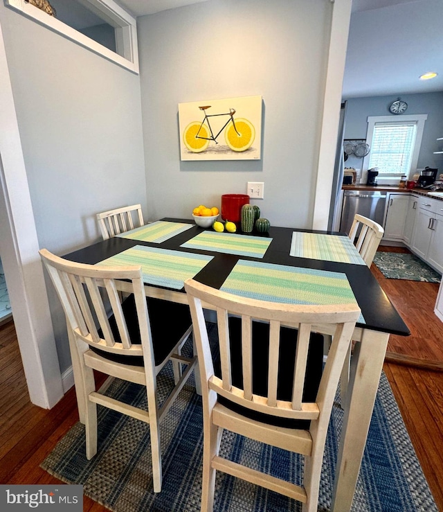 dining space with dark wood finished floors