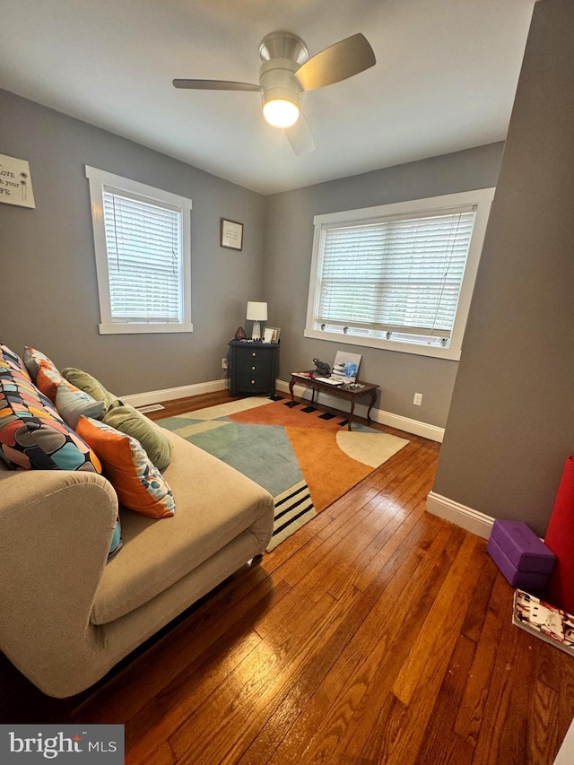 living room featuring plenty of natural light, hardwood / wood-style flooring, and baseboards