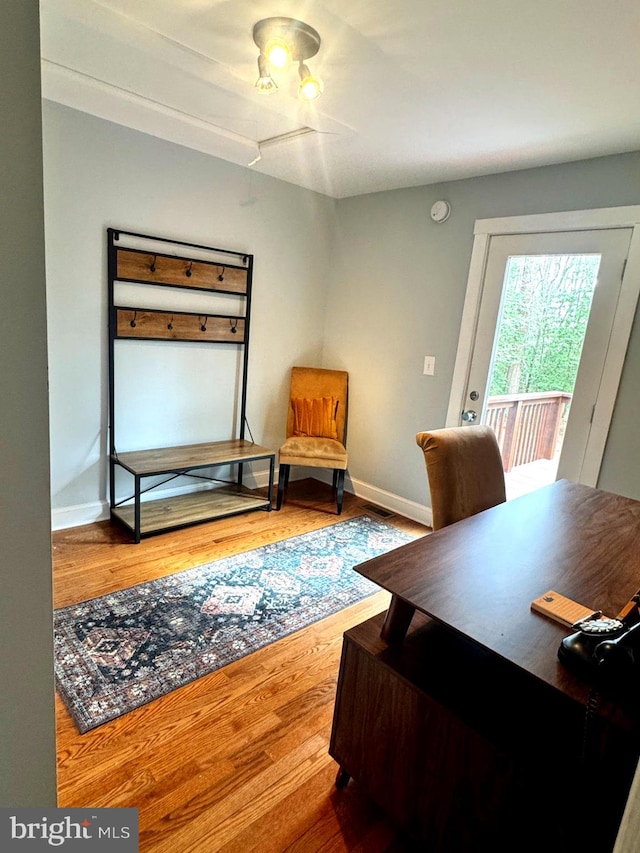 office with visible vents, baseboards, and wood finished floors