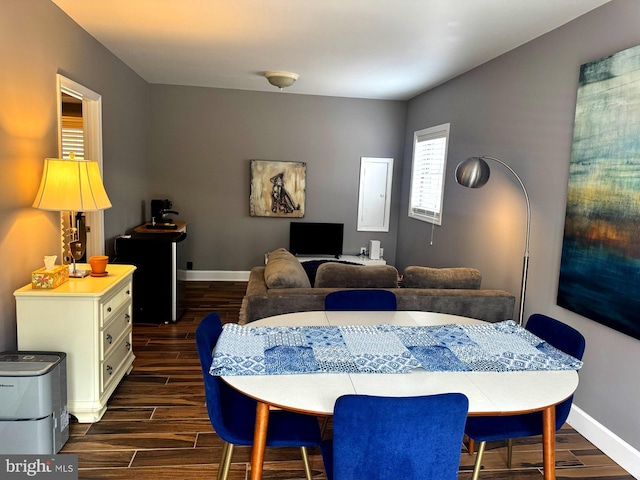 dining room with wood tiled floor and baseboards