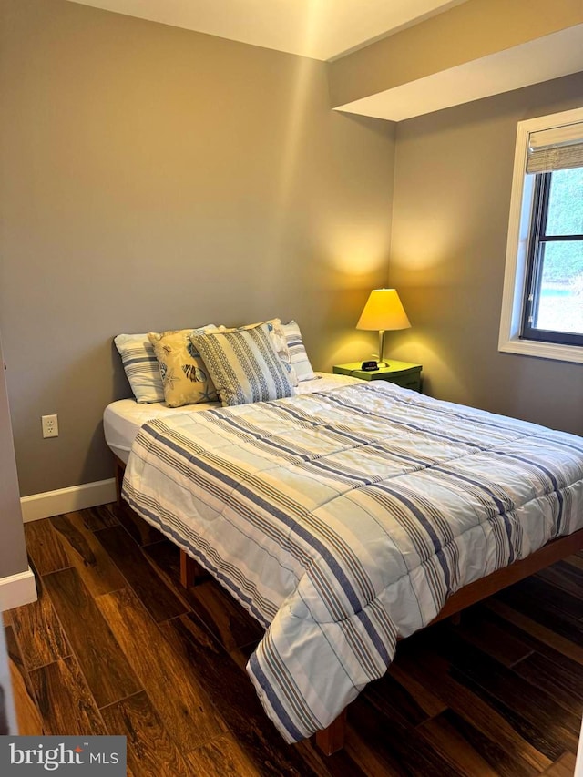 bedroom with wood finished floors and baseboards