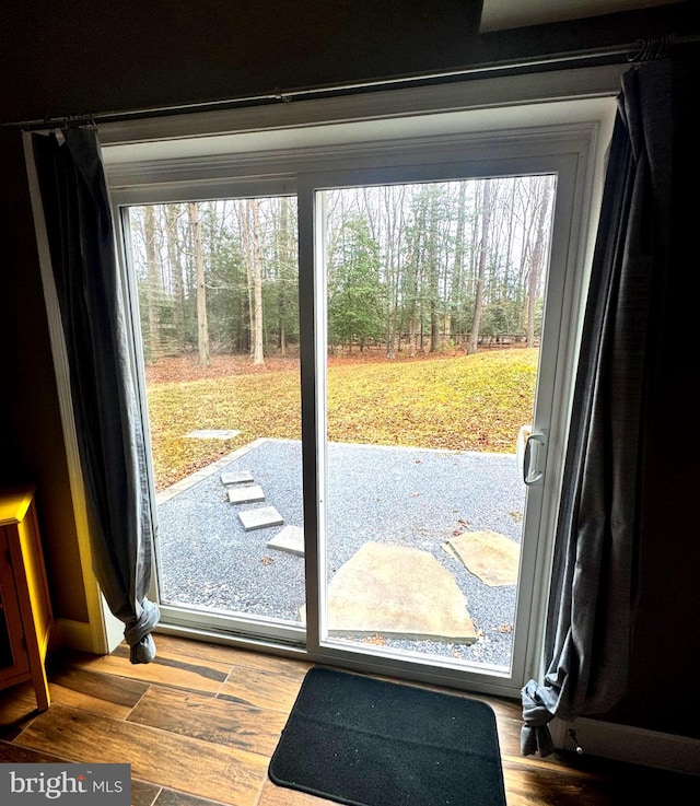 doorway to outside with wood finished floors