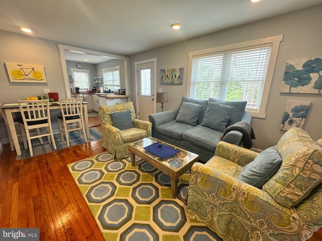 living area with hardwood / wood-style flooring and recessed lighting