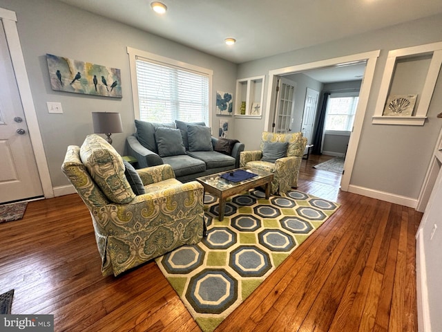 living area with dark wood-style floors and baseboards