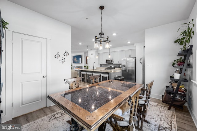 dining area featuring baseboards, recessed lighting, and light wood-style floors