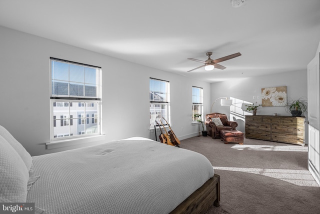 carpeted bedroom featuring baseboards and a ceiling fan